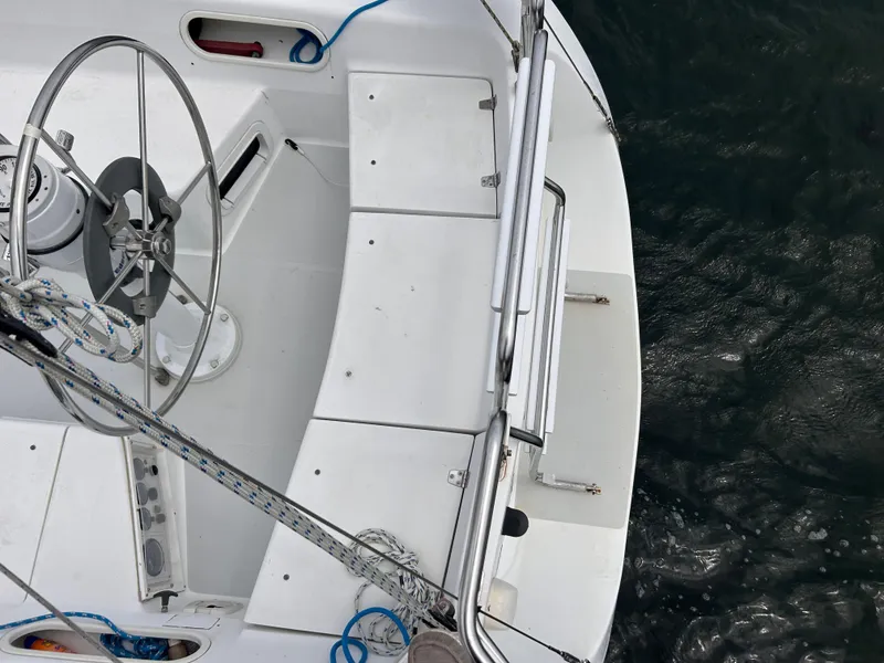 Slide: The Image of Cockpit view of a 1999 Catalina 270 sailboat with steering wheel and ropes. - 13