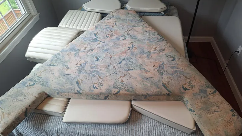 Slide: The Image of Cushions from a 1999 Catalina 270 boat, arranged indoors near a window. - 30