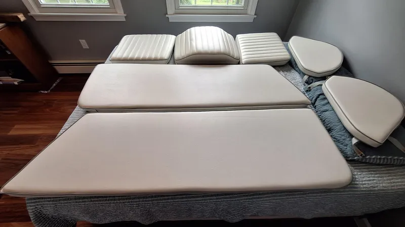 Slide: The Image of Cushions from a 1999 Catalina 270 boat, arranged on a bed indoors. - 31