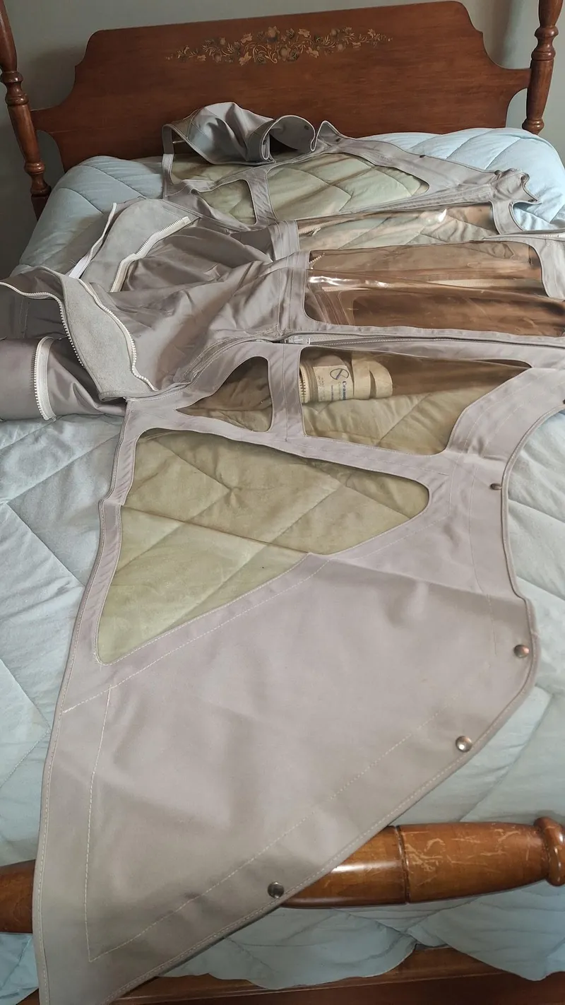Slide: The Image of Protective canvas cover for 1999 Catalina 270 sailboat, displayed on a bed. - 34