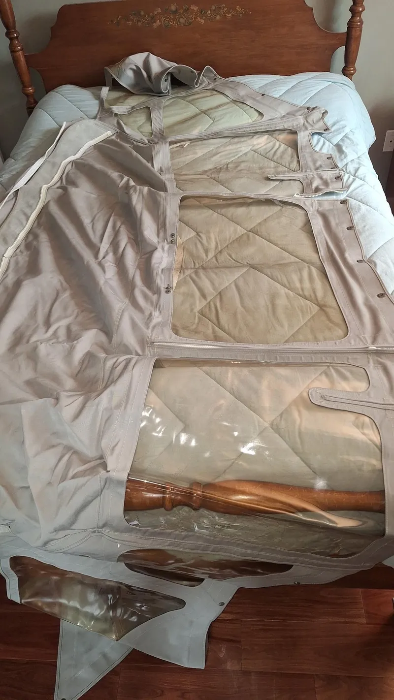 Slide: The Image of Sailboat cover for 1999 Catalina 270, displayed on a bed with wooden headboard. - 35