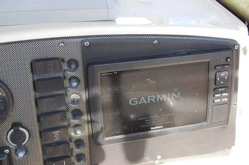Slide: The Image of Garmin echomap SV on 2006 Scout 240 boat dashboard with control switches. - 12