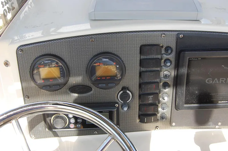 Slide: The Image of Control panel of a 2006 Scout 240 boat with Yamaha gauges and Garmin display. - 13