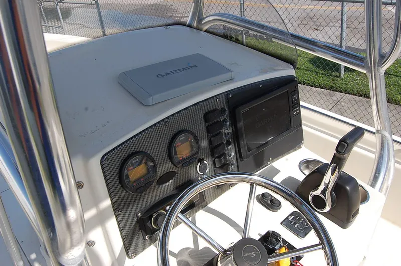 Slide: The Image of 2006 Scout 240 boat dashboard with Garmin navigation system and steering wheel. - 14