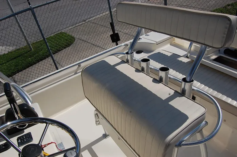 Slide: The Image of 2006 Scout 240 boat interior with steering wheel and rod holders. - 16