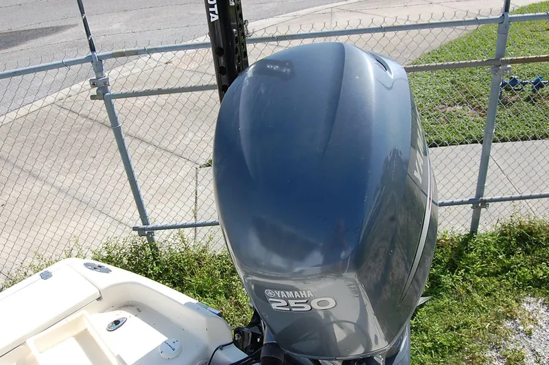 Slide: The Image of Yamaha 250 outboard motor on a 2006 Scout 240 boat, near a chain-link fence. - 17