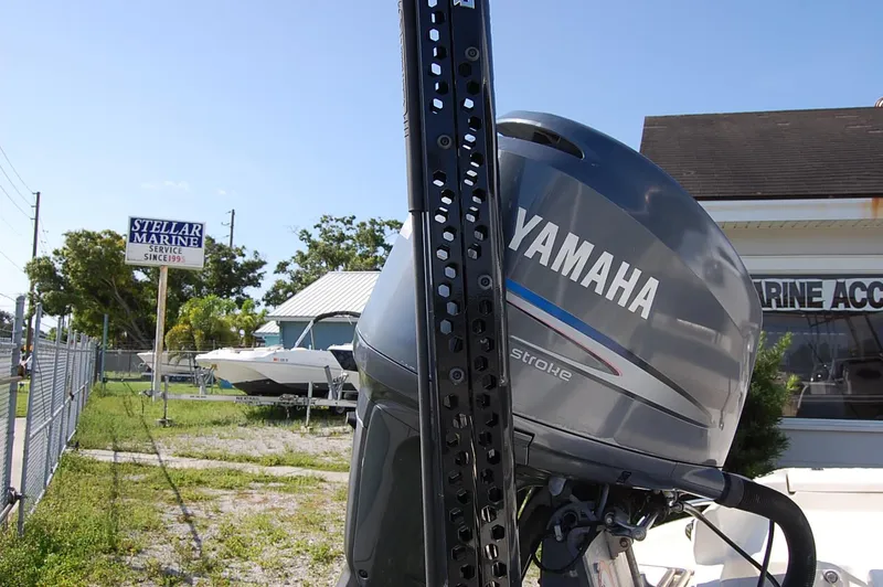 Slide: The Image of Yamaha outboard motor at Stellar Marine, with boats and service sign in background. - 8