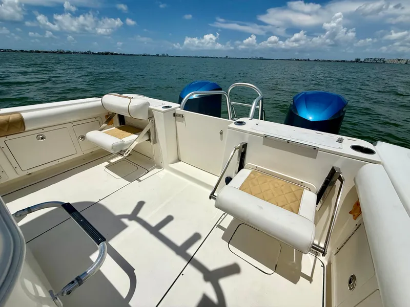 Slide: The Image of 2014 World Cat 295 CC boat with dual engines on open water. - 15