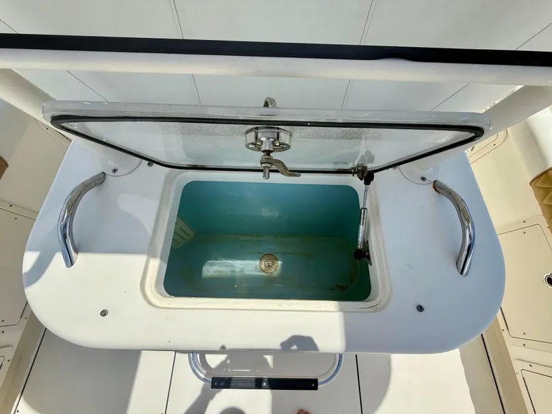 Slide: The Image of Open livewell on 2014 World Cat 295 CC boat, featuring stainless steel handles. - 16