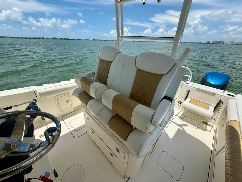 Slide: The Image of 2014 World Cat 295 CC boat interior with cushioned seating and ocean view. - 20