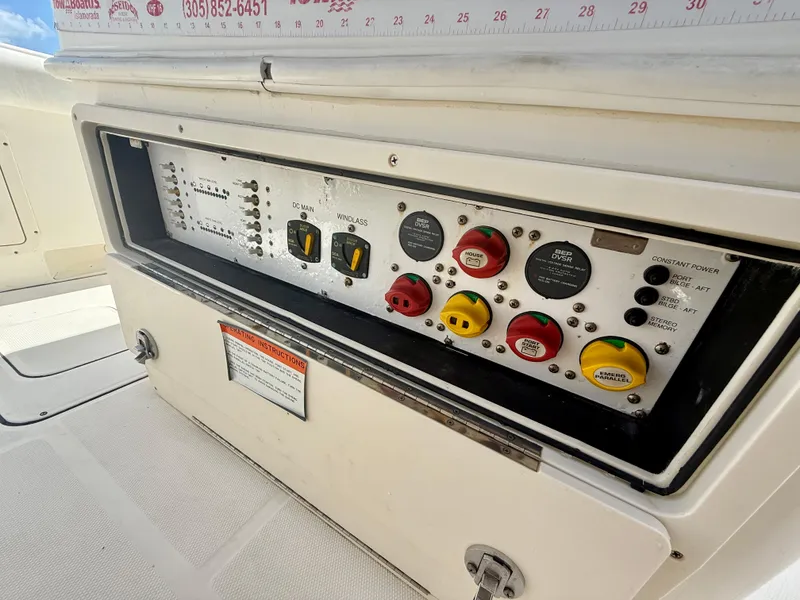 Slide: The Image of Control panel of a 2014 World Cat 295 CC boat, featuring various switches and dials. - 22