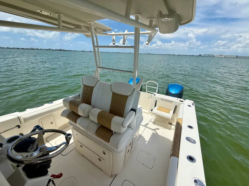 Slide: The Image of 2014 World Cat 295 CC boat interior with helm, seating, and ocean view. - 26