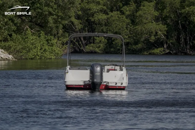 Slide: The Image of 2023 Hurricane SunDeck Sport 205 OB boat cruising on a serene river. - 3