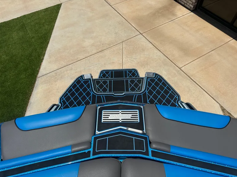 Slide: The Image of 2020 Malibu Wakesetter 25 LSV boat with blue and gray deck design. - 10