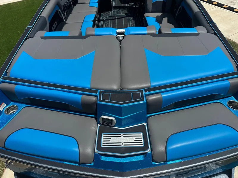 Slide: The Image of 2020 Malibu Wakesetter 25 LSV interior with blue and gray seating, showcasing luxury design. - 11