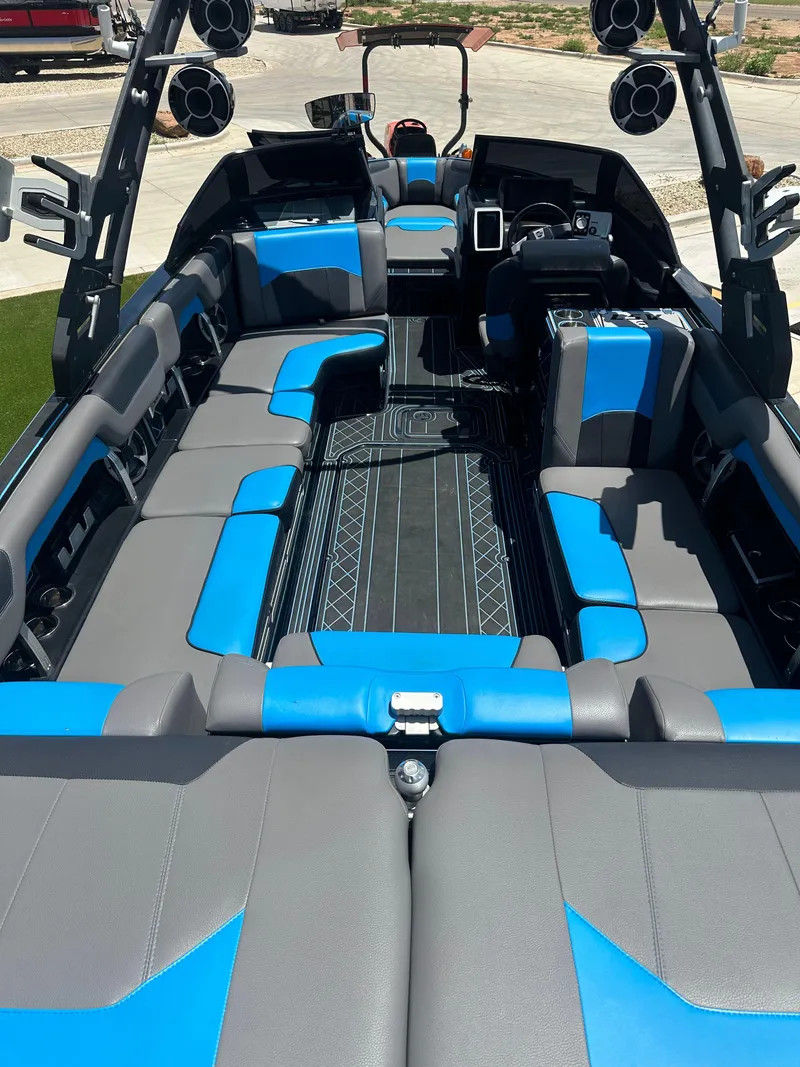 Slide: The Image of 2020 Malibu Wakesetter 25 LSV interior with blue and gray seating, premium sound system. - 12