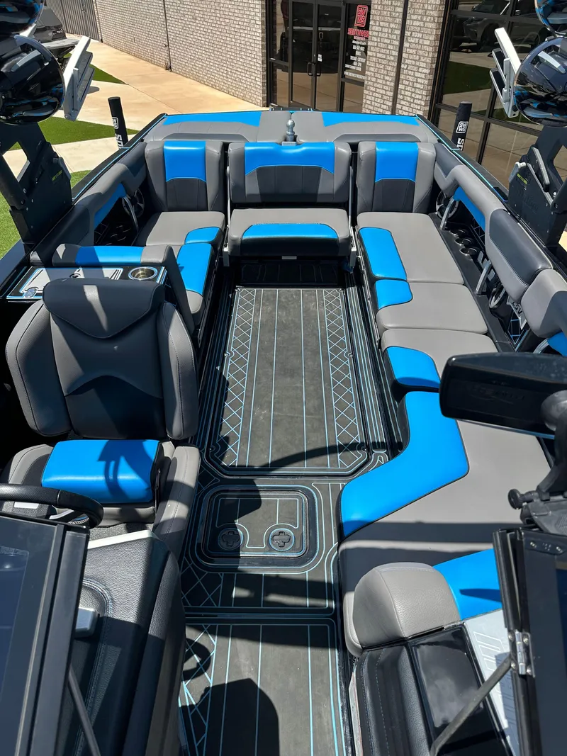 Slide: The Image of 2020 Malibu Wakesetter 25 LSV interior with blue and gray seating, modern design. - 20