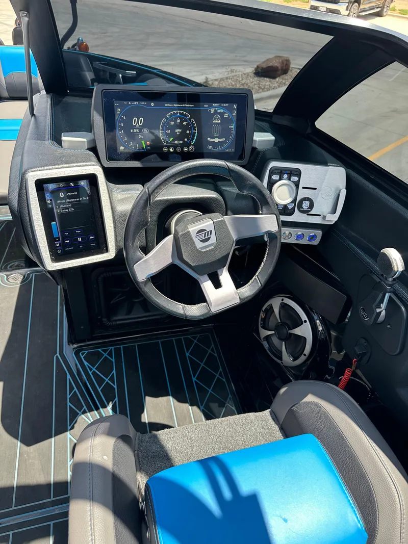 Slide: The Image of 2020 Malibu Wakesetter 25 LSV dashboard with steering wheel and digital displays. - 22