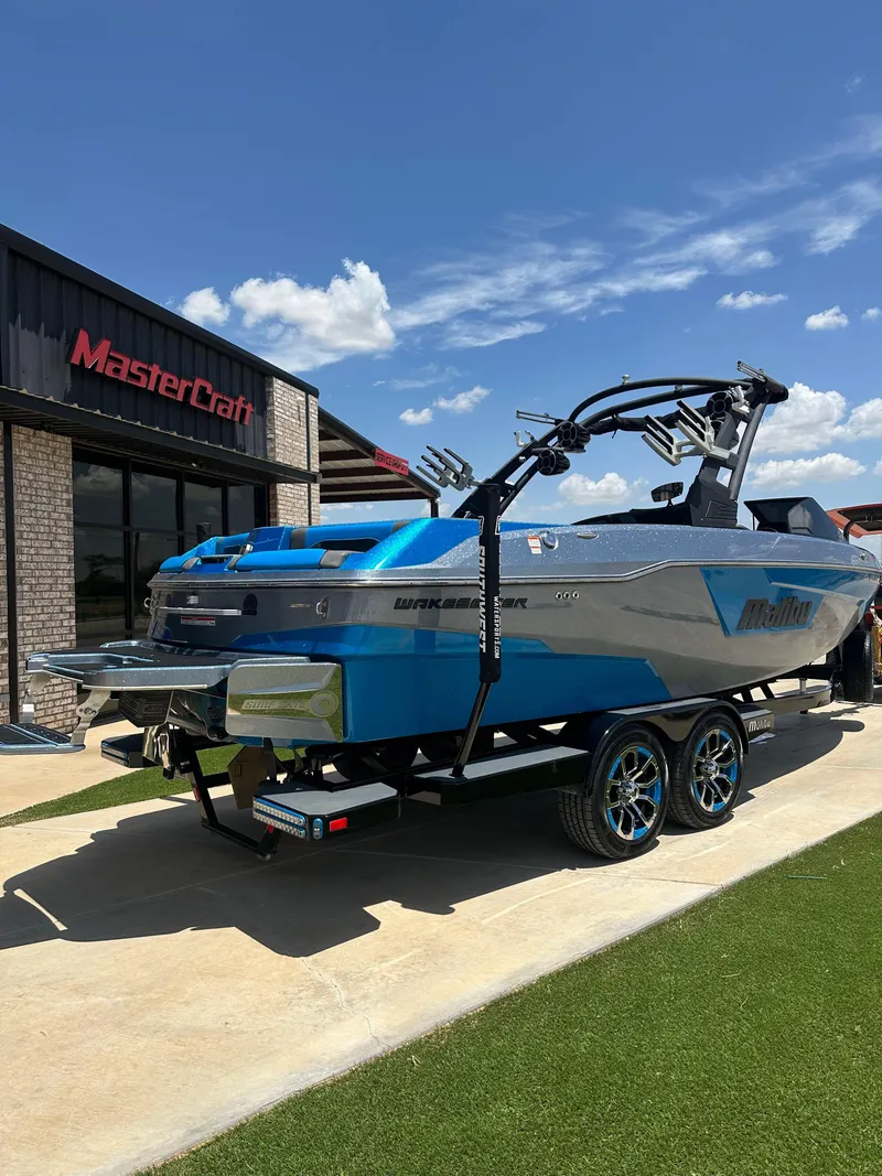 Slide: The Image of 2020 Malibu Wakesetter 25 LSV boat on trailer outside MasterCraft dealership. - 3