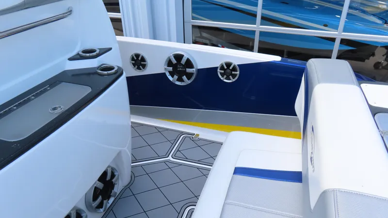 Slide: The Image of 2016 Sunsation 34 CCX boat interior with seating, speakers, and cup holders. - 12