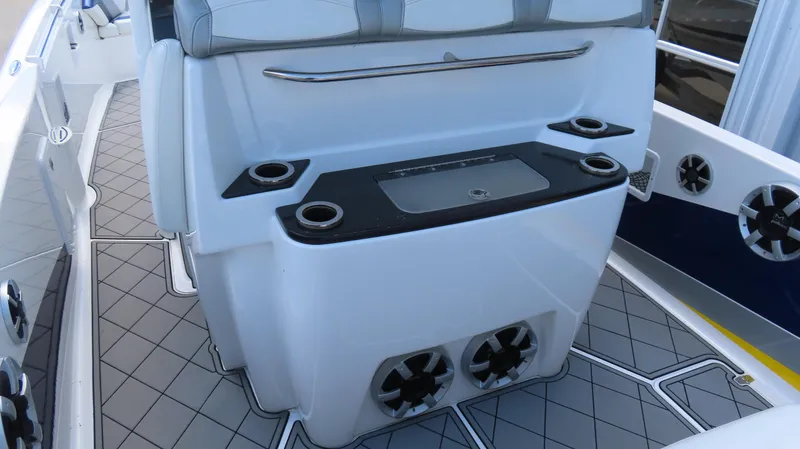 Slide: The Image of 2016 Sunsation 34 CCX boat interior with seating, cup holders, and modern design. - 13