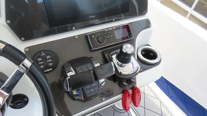 Slide: The Image of 2016 Sunsation 34 CCX boat dashboard with Garmin display and control panel. - 16