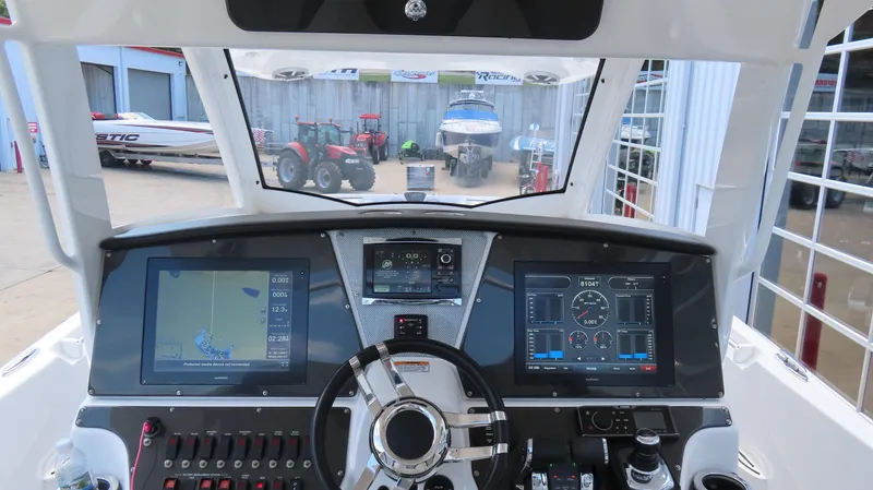 Slide: The Image of Interior view of 2016 Sunsation 34 CCX boat cockpit with advanced navigation displays. - 21