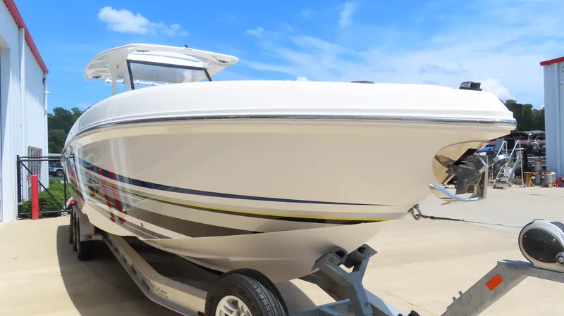 Slide: The Image of 2016 Sunsation 34 CCX boat on trailer, parked outdoors under blue sky. - 4