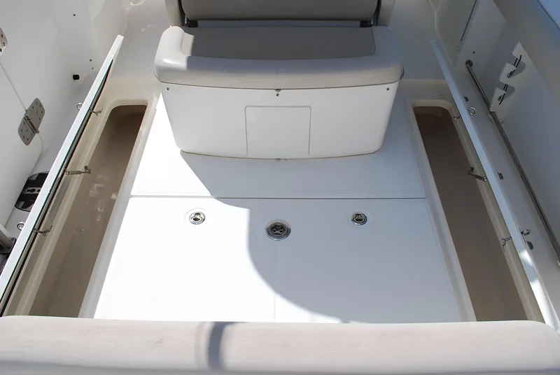 Slide: The Image of 2017 Boston Whaler 330 Outrage boat interior with storage compartments open. - 13