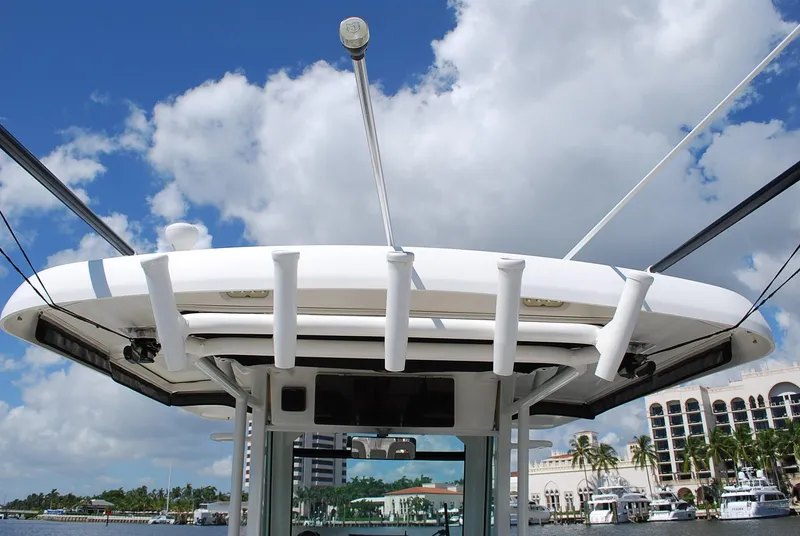 Slide: The Image of Boston Whaler 330 Outrage 2017 boat with rod holders, under a blue sky with clouds. - 14