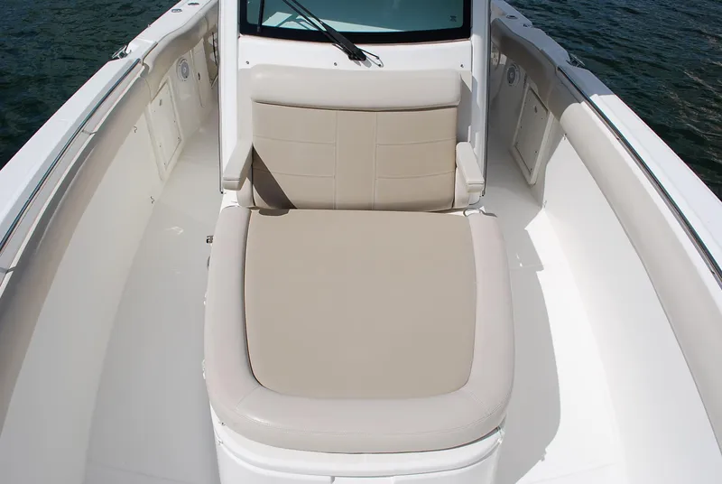 Slide: The Image of 2017 Boston Whaler 330 Outrage boat interior with cushioned seating. - 17