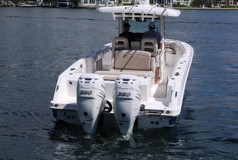 Slide: The Image of 2017 Boston Whaler 330 Outrage boat with twin Mercury 350 engines on water. - 2