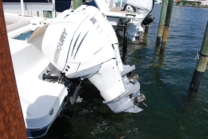 Slide: The Image of 2017 Boston Whaler 330 Outrage with Mercury Verado outboard engines docked in marina. - 23