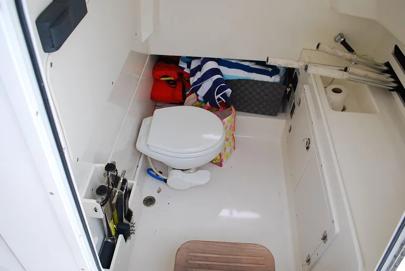 Slide: The Image of Interior of 2017 Boston Whaler 330 Outrage boat with toilet and storage area. - 27