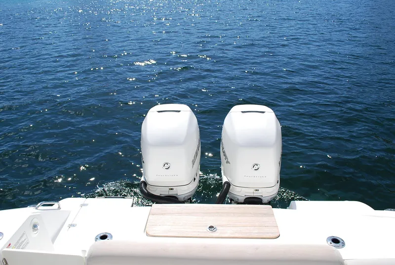 Slide: The Image of 2017 Boston Whaler 330 Outrage with twin outboard engines on open water. - 5