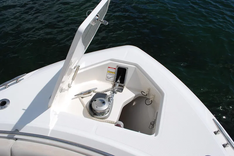Slide: The Image of 2017 Boston Whaler 330 Outrage anchor compartment with open hatch, showing anchor and rope. - 9