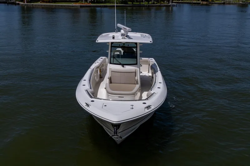 Slide: The Image of 2020 Boston Whaler 330 Outrage boat on calm water, front view. - 11