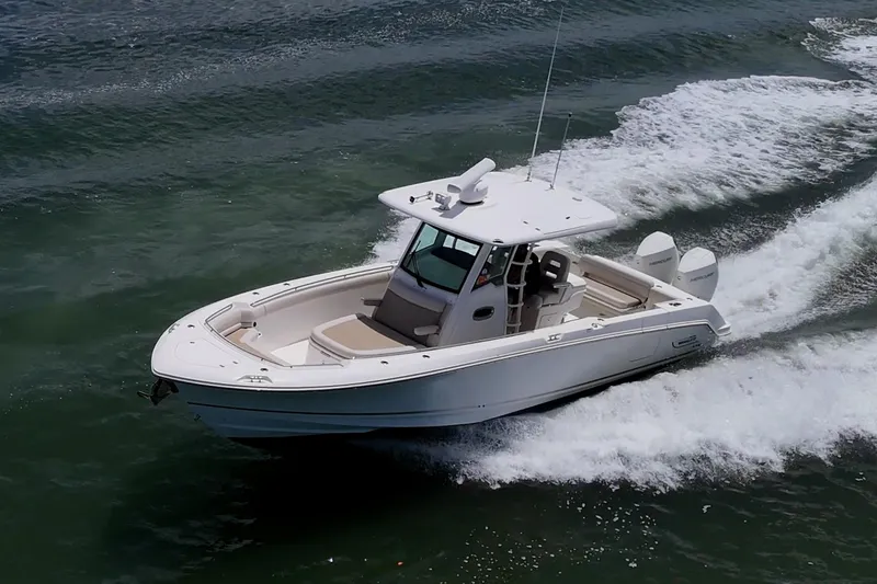 Slide: The Image of 2020 Boston Whaler 330 Outrage cruising on open water, showcasing sleek design and performance. - 18