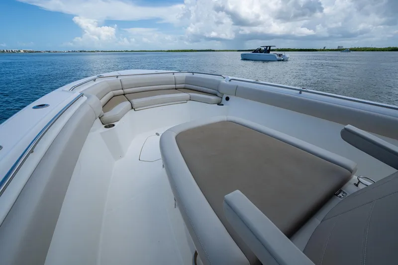 Slide: The Image of 2020 Boston Whaler 330 Outrage boat interior with spacious seating on calm water. - 24