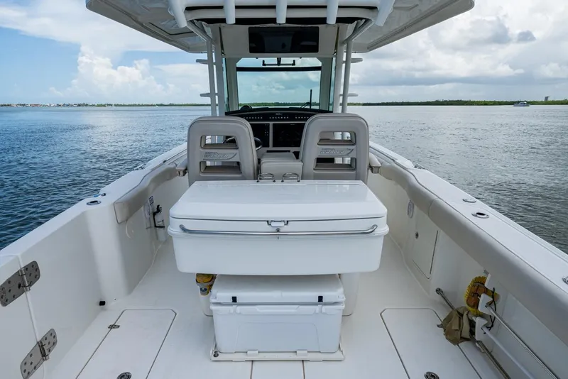 Slide: The Image of 2020 Boston Whaler 330 Outrage boat interior with seating and ocean view. - 33