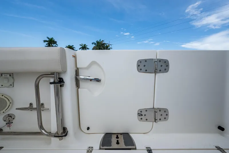 Slide: The Image of 2020 Boston Whaler 330 Outrage boat interior with stainless steel fittings and blue sky background. - 41