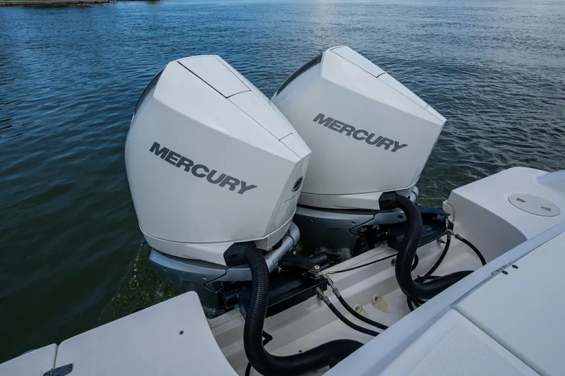 Slide: The Image of Twin Mercury outboard engines on a 2020 Boston Whaler 330 Outrage boat. - 44