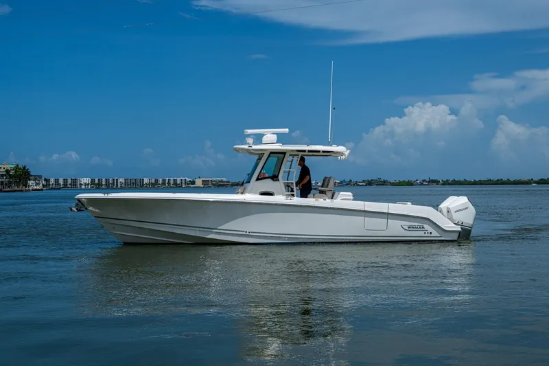 Slide: The Image of 2020 Boston Whaler 330 Outrage boat on calm water under blue sky. - 5