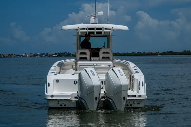 Slide: The Image of 2020 Boston Whaler 330 Outrage boat with dual engines on calm water. - 8