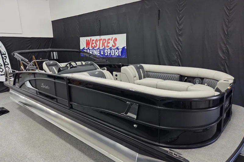 The Image of 2026 Barletta Lusso 25UC pontoon boat in showroom, featuring sleek black design and luxurious seating. - 0