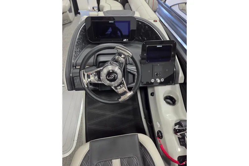 Slide: The Image of 2026 Barletta Lusso 25UC boat dashboard with steering wheel and digital displays. - 12
