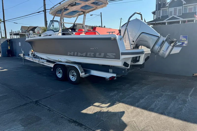 Slide: The Image of 2025 Nimbus Tender 8 boat on trailer, parked outdoors, showcasing sleek design and powerful engine. - 13