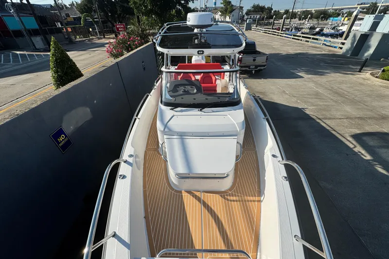 Slide: The Image of 2025 Nimbus Tender 8 boat with sleek design, docked in a marina setting. - 17