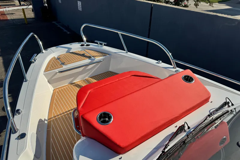 Slide: The Image of 2025 Nimbus Tender 8 boat with red seating and sleek deck design. - 19