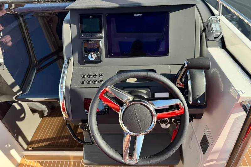 Slide: The Image of Steering console of 2025 Nimbus Tender 8 boat with modern controls and display. - 21